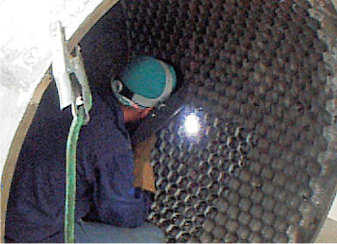 A Diamond Refractory Services welder installs hex cells for pack and ram refractory A Diamond Refractory Services welder installs hex cells for pack and ram refractory